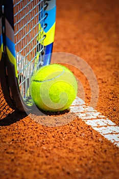 Tennis Ball and Racquet on the court