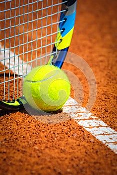 Tennis Ball and Racquet on the court