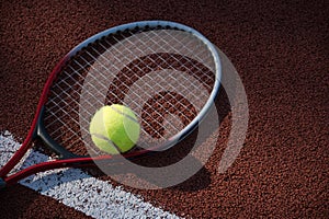 Tennis ball, racquet on hard court surface