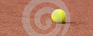 Tennis ball on a tennis clay court. Horizontal sport poster, greeting cards, headers, website