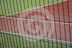 A tennis ball on the tennis court.