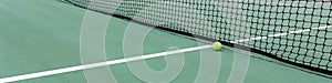 Tennis ball on tennis court with net