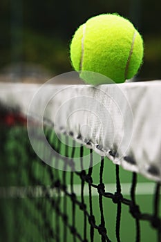 Tennis ball on tennis net. Conceptual image shot