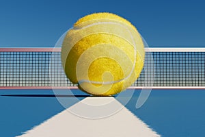 Tennis ball on the white line of the court against the background of a sports playground with a net.