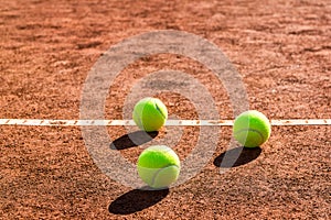 Tennis balls on a clay court