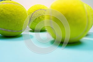 Tennis balls close up on blue hard tennis court. Copy space.