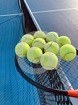 tennis balls on racket on the tennis court close up shot