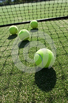 Tennis balls on tennis grass court.