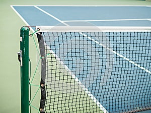 Tennis blue hard court with net before competition in sunny day