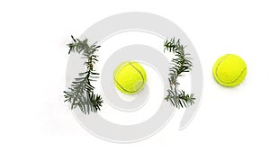 Tennis Christmas and 2020 New Year concept with tennis balls and fir branches with numbers on white snow, isolated.
