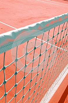 a tennis court image with peach tones, featuring a white net