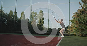 At tennis court outside professional are playing a sportiv woman tennis game.