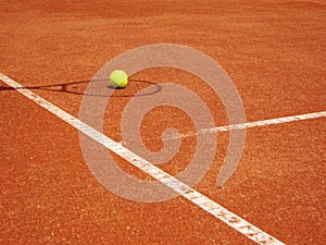 Tennis court and racket shadow with ball