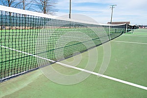 Tennis courts with blue sky and net