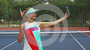 Tennis girl taking selfies on a court