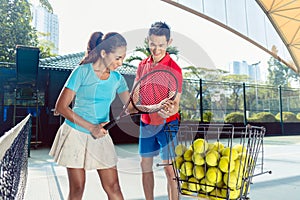 Tennis instructor teaching the correct grip for holding the racket