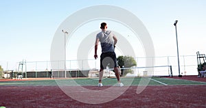 Tennis match player serving ball to opponent