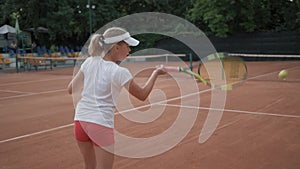 Tennis match, sports player child girl with contestant hitting racket on ball pass through net to each other at court