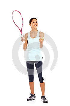 Tennis is my favourite past time. Full length image of a happy young woman holding a tennis racket and ball getting