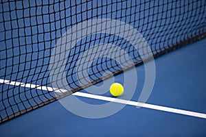 Tennis net and ball and hard court. Professional sport and tennis competition concept