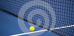 Tennis net and ball and hard court. Professional sport and tennis competition concept