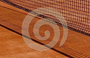 Tennis net and brown court. Individual sport