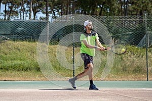 Tennis player hitting backhand at ball