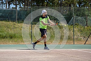 Tennis player hitting backhand at ball