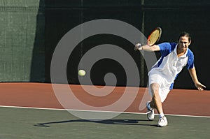Tennis Player Hitting Backhand On Court photo
