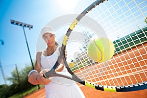 Tennis player hitting the ball