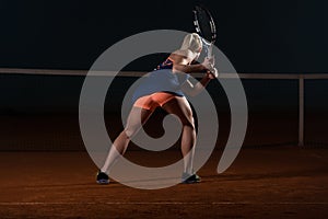 Tennis Player Hitting The Ball On Tennis Court photo
