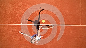 Tennis player hitting ball on tennis terrain photo