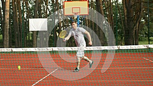 Tennis player hitting forehand near the net