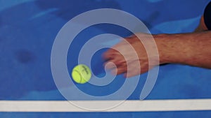 Tennis player holding the ball and getting ready to serve. Close-up feet tennis player preparing to serve. Knocking the