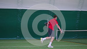 Tennis player pitches a ball during a jump