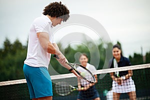 Tennis player prepares to serve ball during tennis match