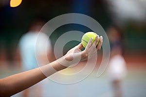 Tennis player prepares to serve ball during tennis match