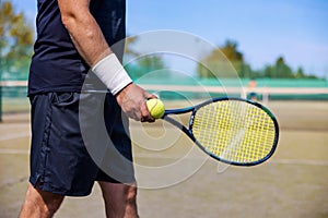 tennis player with racket and ball in hands ready to play at outdoor court