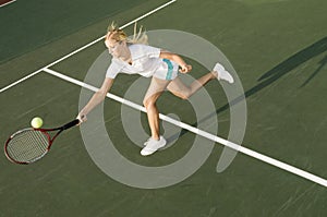 Tennis Player Reaching To Hit Ball