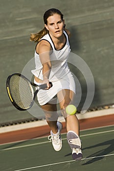 Tennis Player Reaching To Hit Ball