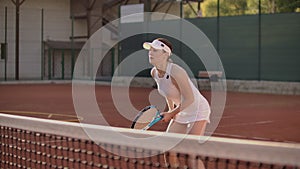 Tennis Player Reaching To Hit Ball. Female tennis player reaching to hit the tennis ball on court.