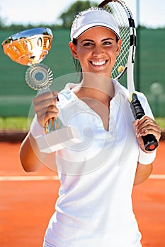 Tennis player showing golden goblet photo