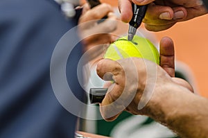 Tennis player signs autograph after win