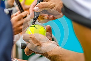 Tennis player signs autograph after win