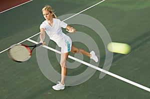 Tennis Player Swinging Racket in Forehand Motion