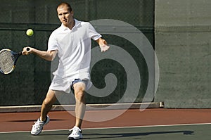 Tennis Player swinging tennis racket