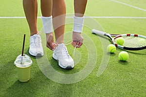 Tennis player tying shoes