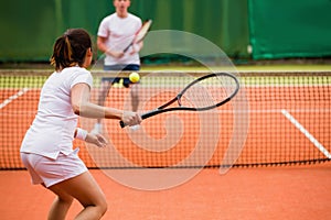 Tennis players playing a match on the court