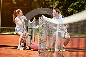 Tennis players refreshing and chatting on break