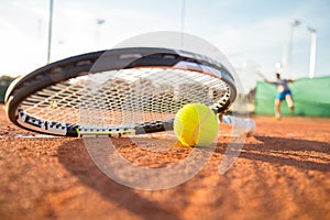 Tennis racket and ball on court